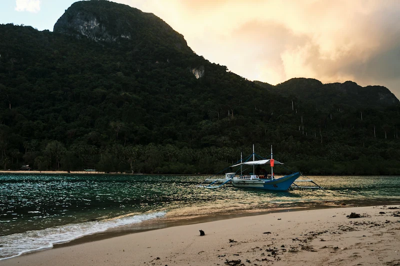 Traditional banca boat at sunset in El Nido, Palawan