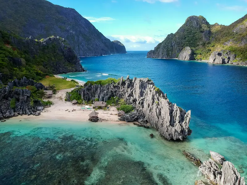 erial view of limestone cliffs and hidden lagoon beach in El Nido, Palawan