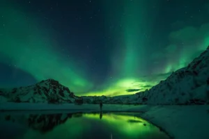 Northern lights over snow-covered mountains in Iceland