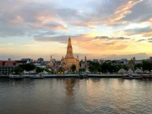 Wat Arun temple at sunset along the river in Bangkok, Thailand