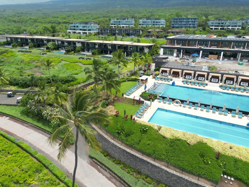 aerial view of a Hawaii resort with pools and volcanic rock landscaping