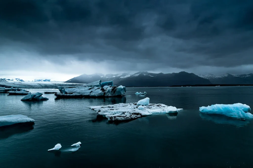 Icebergs floating in a glacier lagoon under stormy Icelandic skies