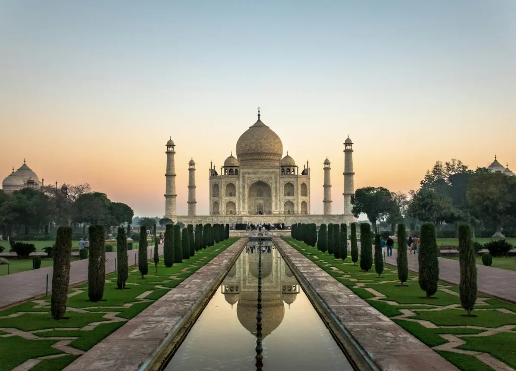 Taj Mahal at sunrise reflected in the garden pool, Agra, India
