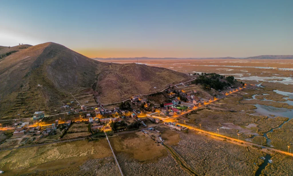Aerial sunset view of Lake Titicaca and the Uros floating islands near Puno, Peru