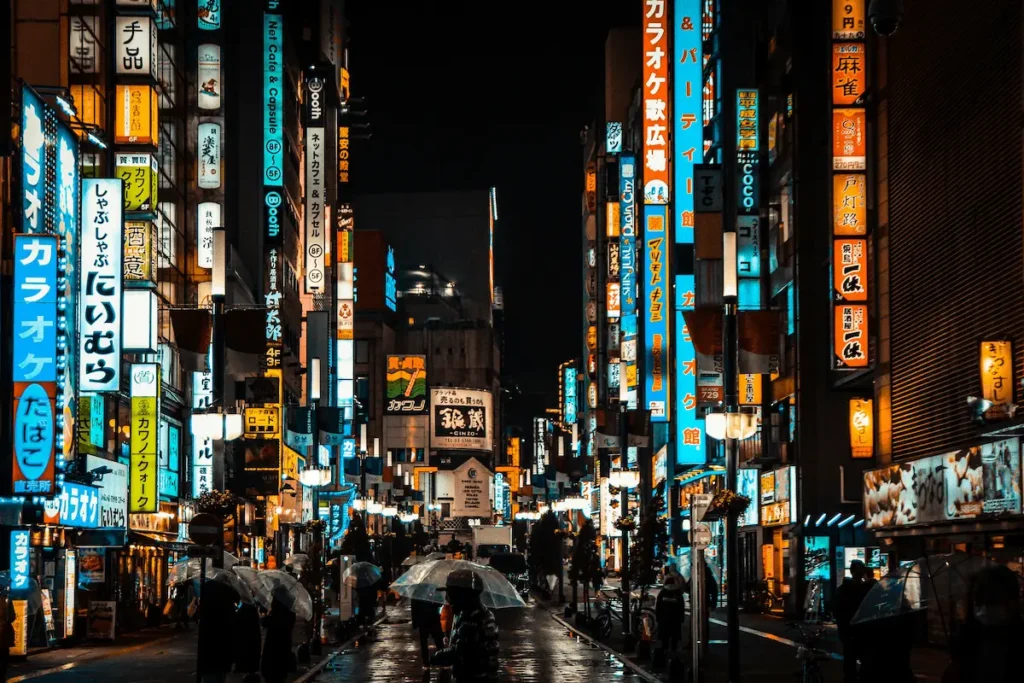 Rainy night street scene with neon signs in Kabukicho, Shinjuku, Tokyo