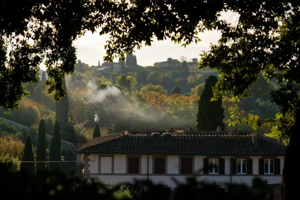 Tuscan countryside near Florence with cypress trees and misty hills