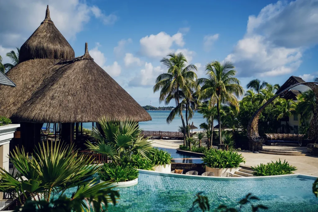 Infinity pool and thatched-roof pavilion at a Mauritius beach resort