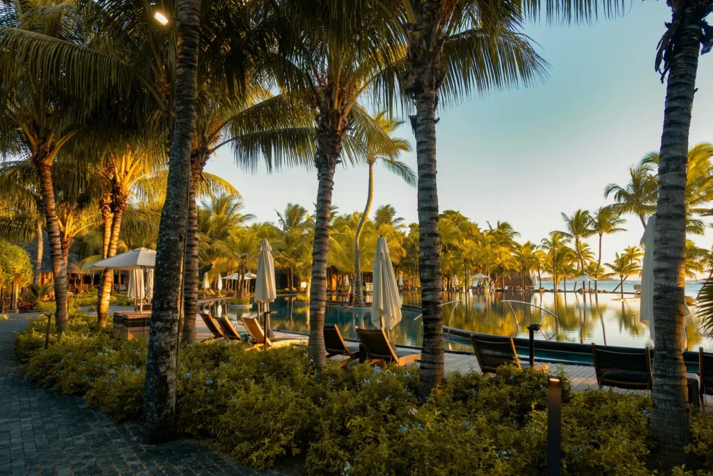 Palm trees and resort pool at sunset in Mauritius