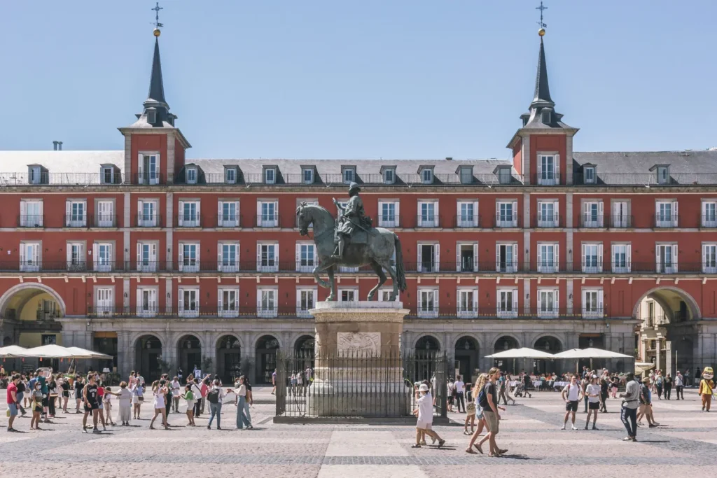 Plaza Mayor in Madrid, Spain, with the equestrian statue of King Philip III and the plaza's red facades