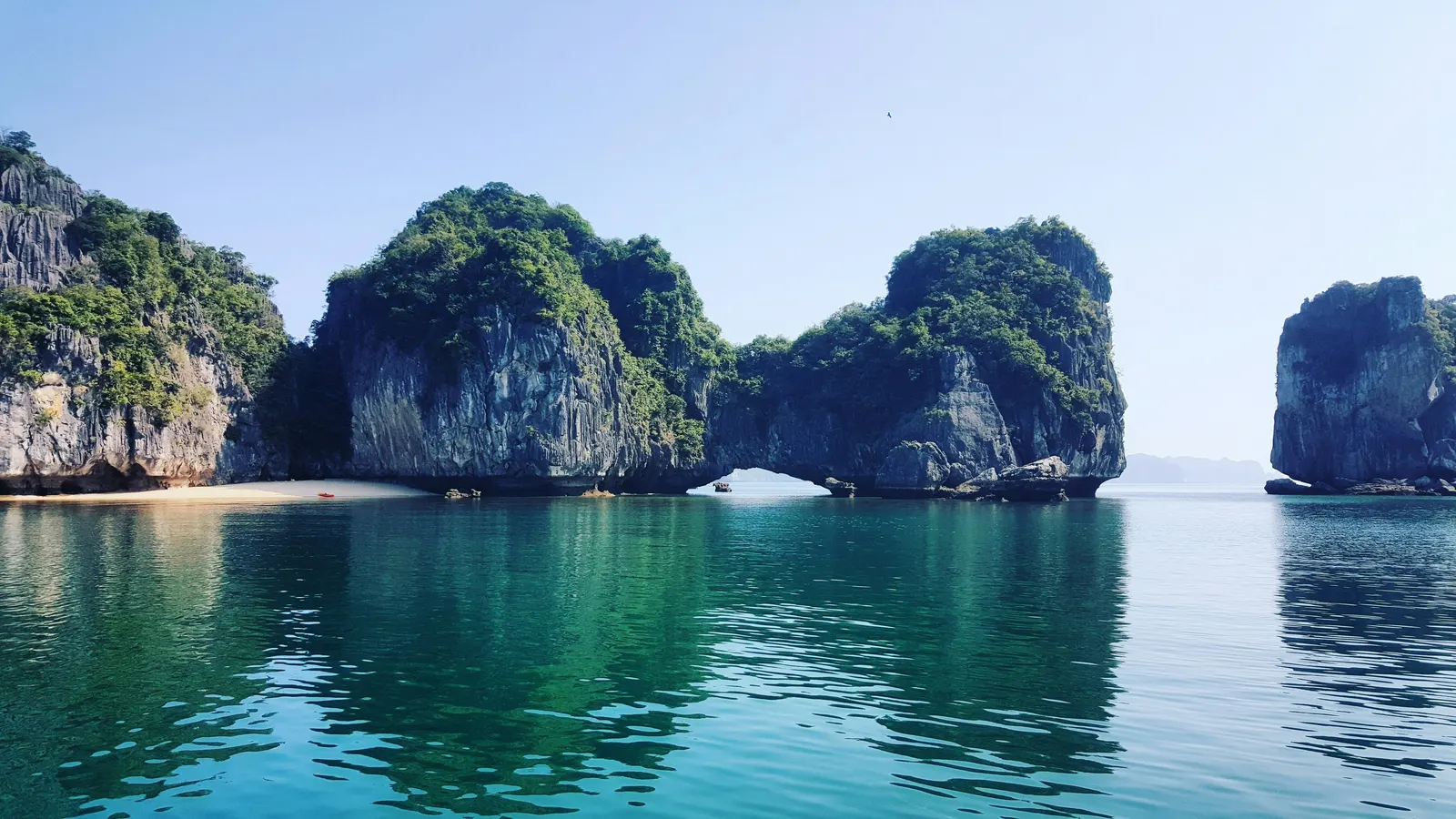 Limestone karst islands rising from turquoise water in Halong Bay, Vietnam