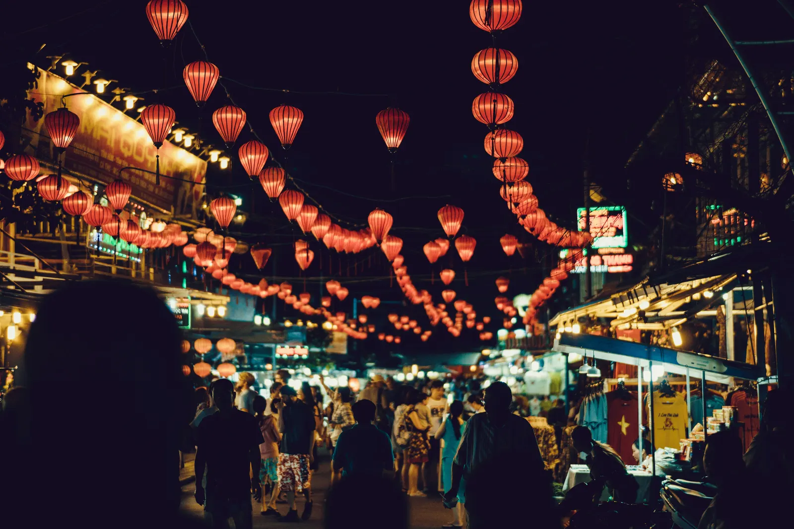 Red and gold silk lanterns strung above a street in Hoi An’s Ancient Town at night