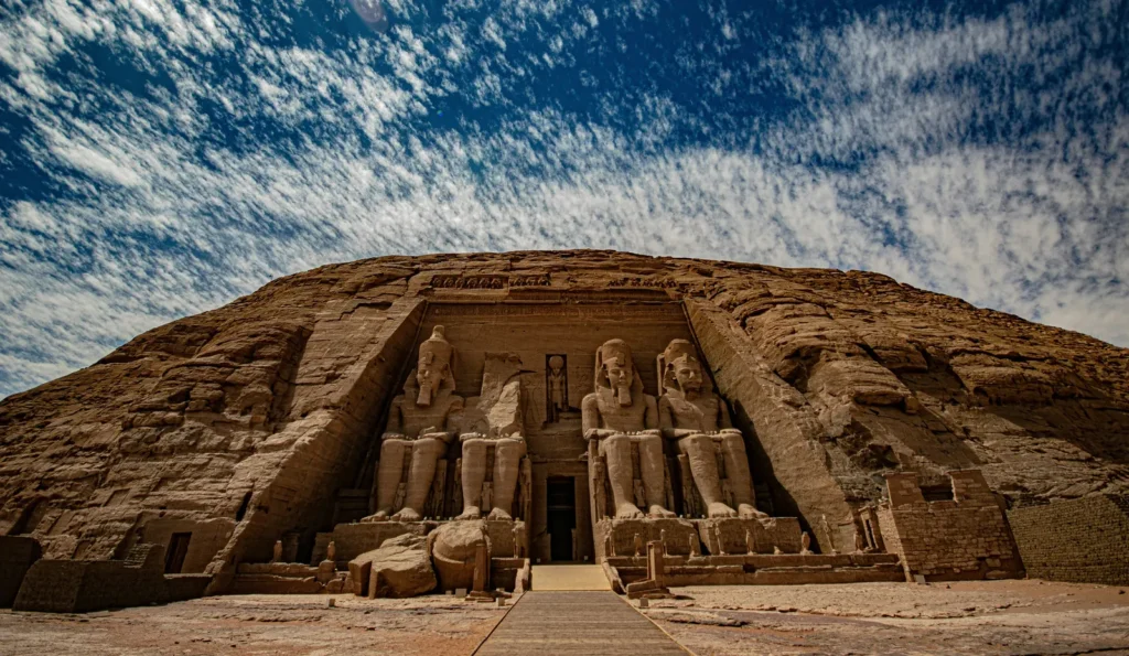 The four seated colossal statues at the entrance of the Great Temple of Abu Simbel in Egypt