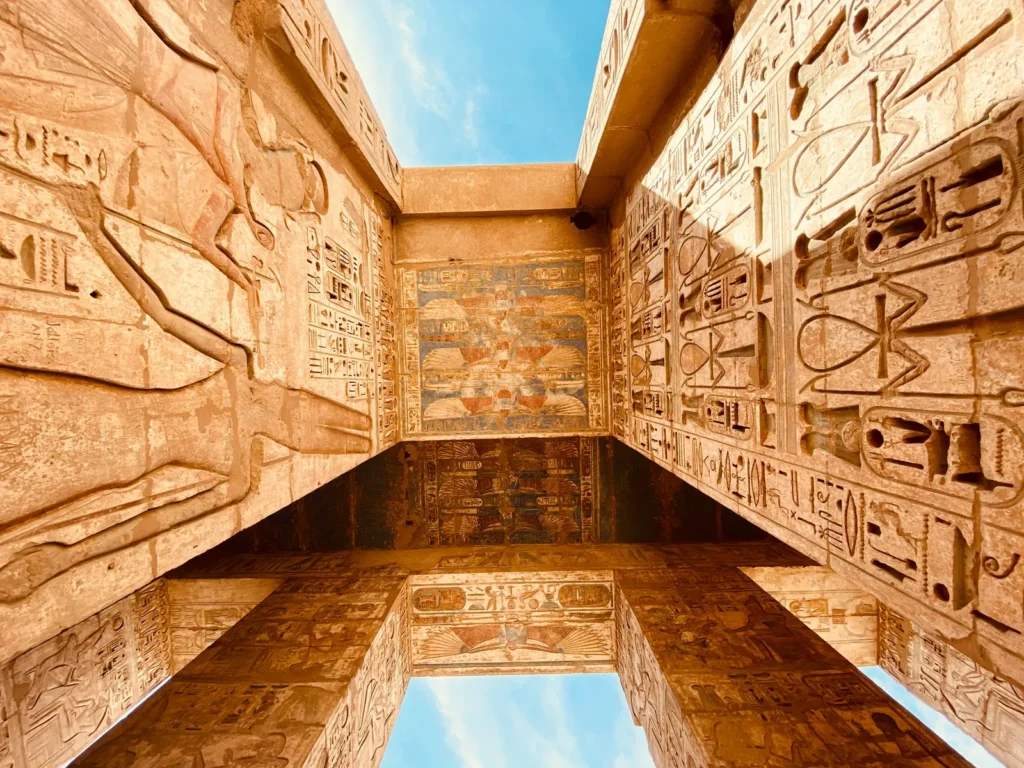 Painted ceiling and hieroglyphic carvings inside an ancient Egyptian temple in the Nile Valley