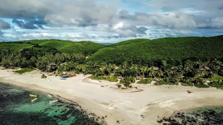 Aerial view of a Yasawa Islands beach and green hills, Fiji