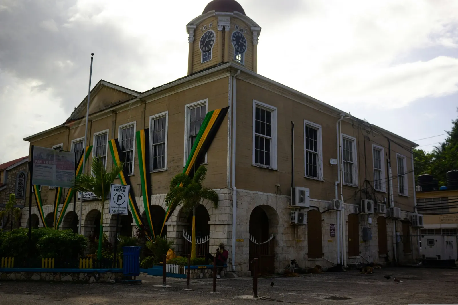 Clock-tower building draped in Jamaica's black, green and gold colours