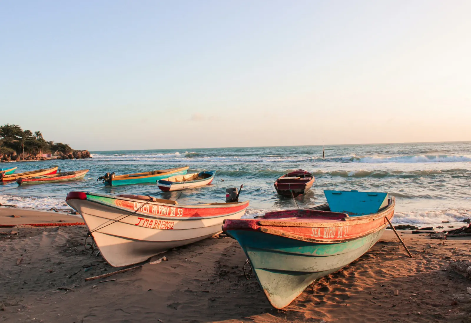 Painted fishing boats on the shore of Jamaica's south coast