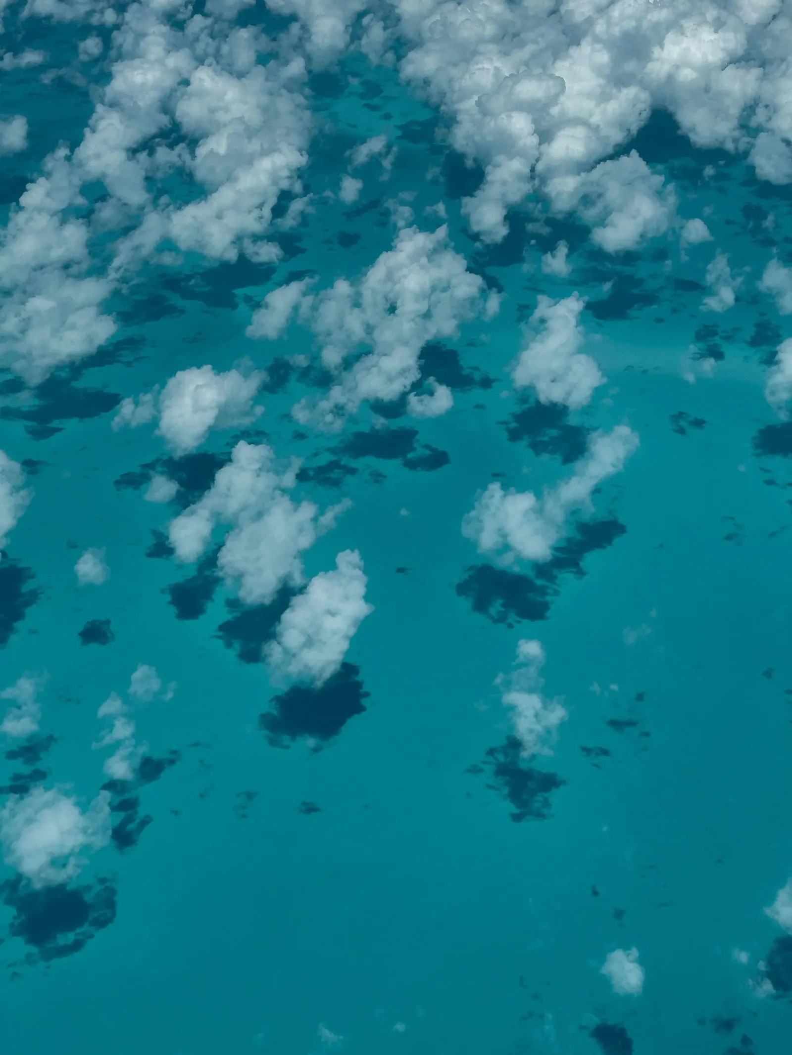 Cumulus clouds casting shadows over the Caribbean Sea